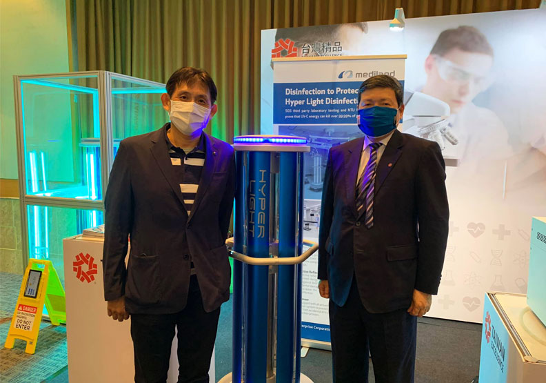 鼎眾總經理陳能淵（左）與價值130萬元的「超紫光滅菌機器人」。