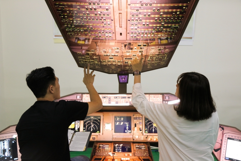 朝陽科大航空學院學生操作駕駛艙模擬訓練器,熟悉儀表位置及相關程序演練。