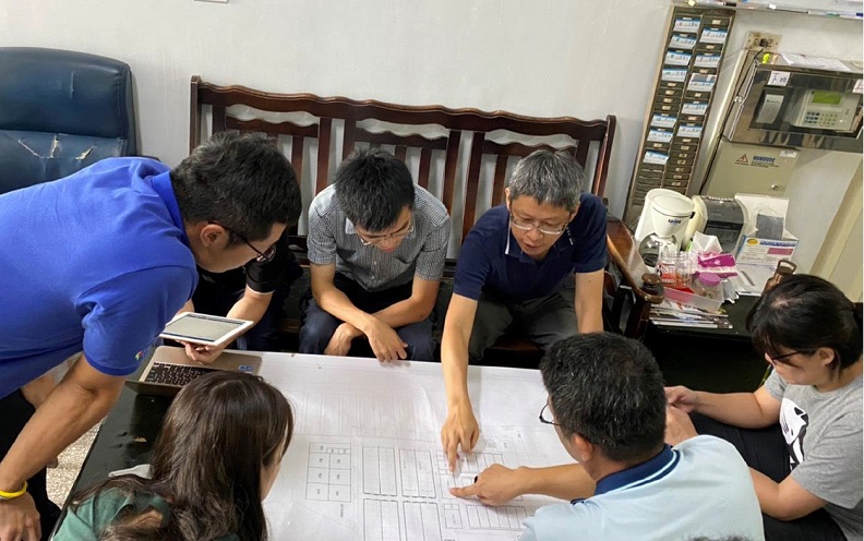 獸醫學系邱明堂主任(後排右一)與牧場工作人員討論生產醫學和疾病防治等相關工作項目。